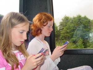Karen and Lara on the coach with their game boys
